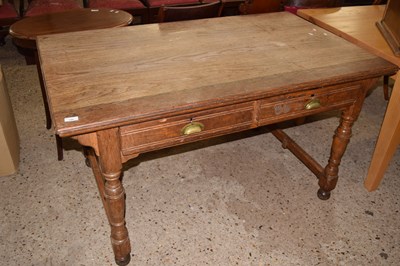 Lot 199 - A Maple & Co oak two drawer writing table on...