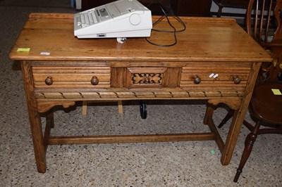 Lot 208 - A 20th Century oak three drawer side table...