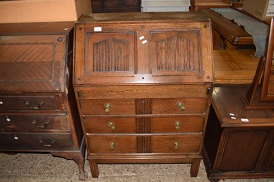 Lot 228 - An oak linen fold front bureau