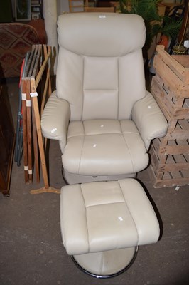 Lot 721 - An easy chair and matching footstool
