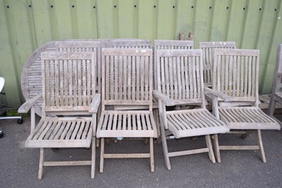 Lot 309 - Teak garden table with eight folding chairs