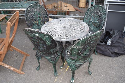 Lot 315 - A cast garden table and four chairs