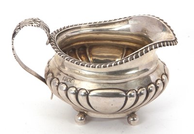 Lot 76 - A late Victorian silver cream jug of oval form,...