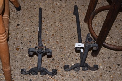 Lot 318 - A pair of iron fire dogs