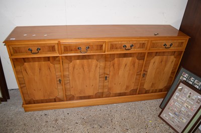 Lot 380 - A reproduction yew wood veneered sideboard
