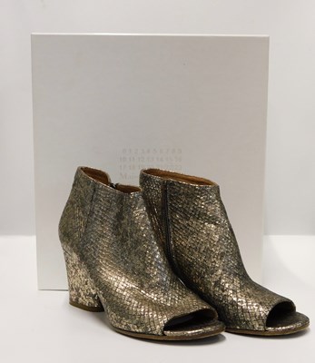 Lot 141 - Maison Margiela: a pair of gold leather faux...