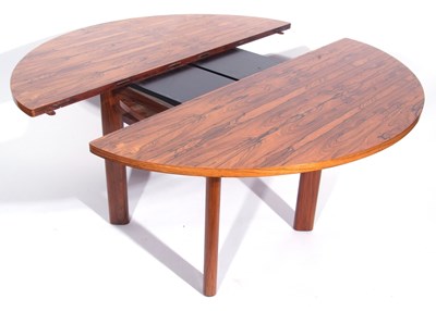 Lot 415 - A mid century Rosewood extending dining table...