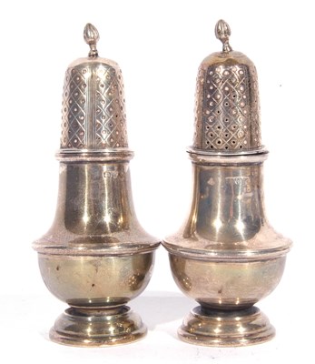 Lot 74 - Pair of George V silver peppers of baluster...