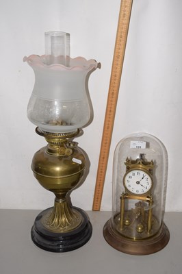 Lot 131 - A brass based oil lamp and an anniversary clock