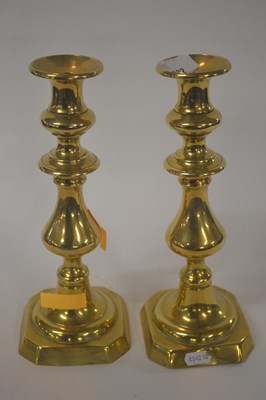 Lot 232 - A pair of brass candlesticks with baluster...