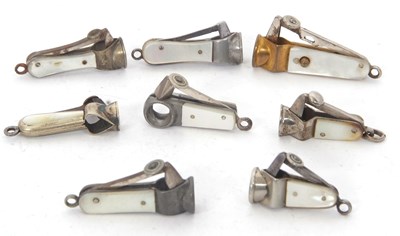 Lot 106 - A group of eight small cigar cutters with...