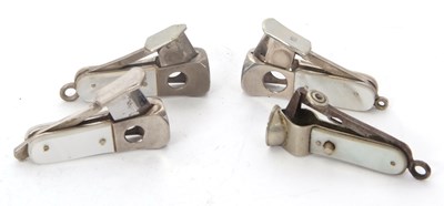 Lot 107 - A group of four steel cigar cutters with...
