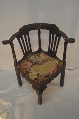 Lot 366 - A Victorian carved oak corner chair decorated...
