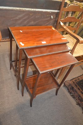 Lot 375 - A nest of three Edwardian mahogany tables, the...