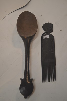 Lot 450 - A large East African wooden spoon with carved...