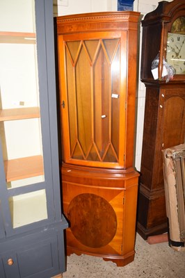 Lot 246 - A yew wood veneered corner display cabinet