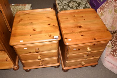 Lot 816 - A pair of three drawer pine bedside cupboards