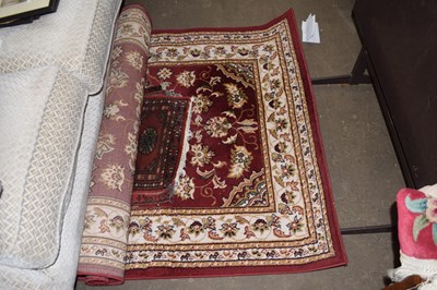 Lot 860 - A burgundy ground rug