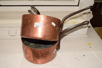 Lot 323 - A set of four vintage copper and iron saucepans