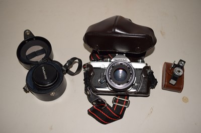 Lot 512 - A cased Olympus camera and lens