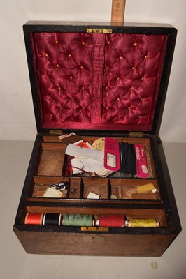 Lot 617 - A wooden multi-levelled sewing box