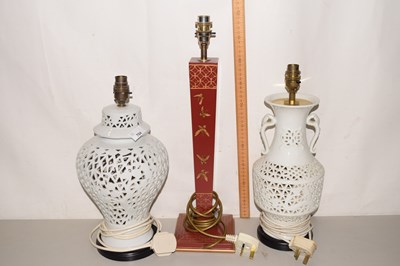 Lot 704 - Pair of ceramic pierced lamp stands together...