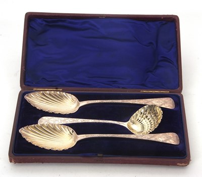 Lot 212 - A cased pair of George III serving spoons...