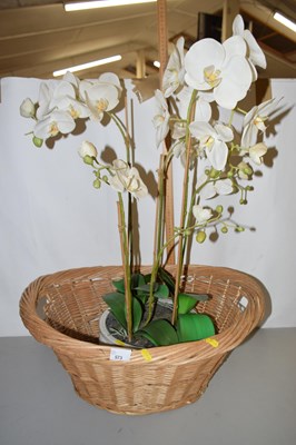 Lot 573 - Large simulated orchid pot plant and a wicker...