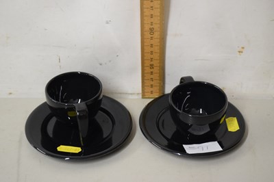 Lot 91 - Pair of Arabia black cups and saucers
