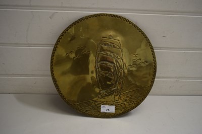 Lot 75 - CIRCULAR BRASS WALL PLAQUE DECORATED WITH A...