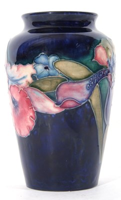 Lot 35 - Moorcroft vase in the orchid pattern on blue...