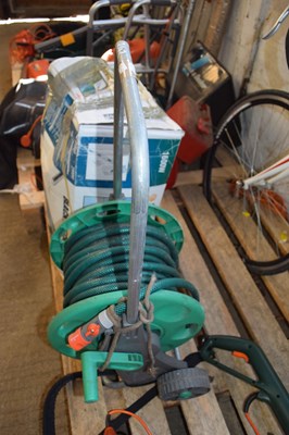 Lot 242 - Garden hose and reel