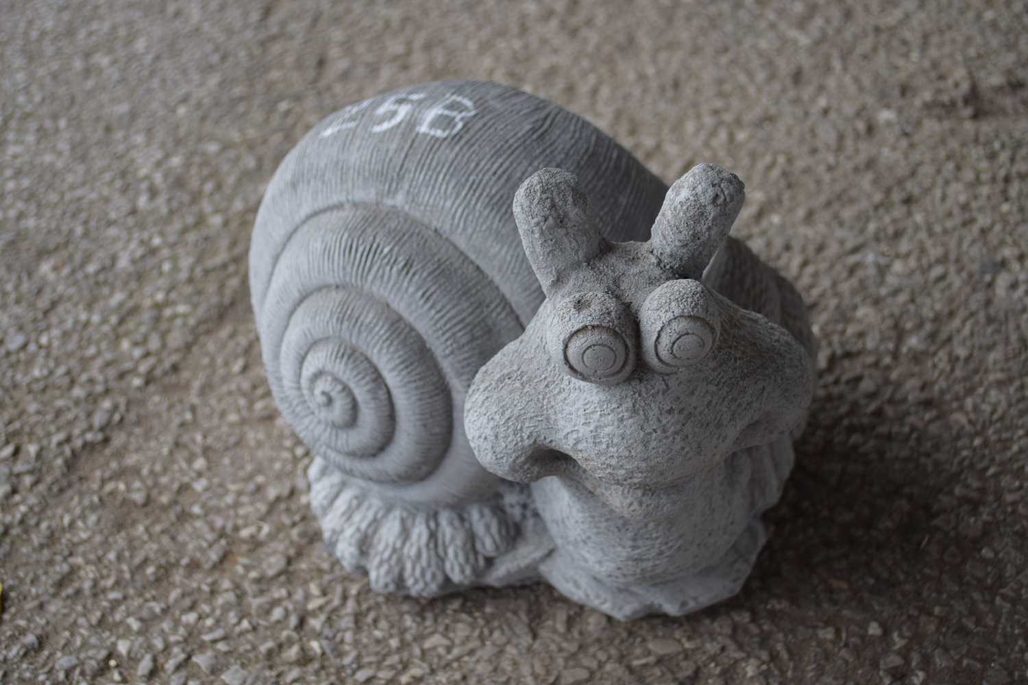 Lot 25 - Composite garden ornament formed as a snail,...