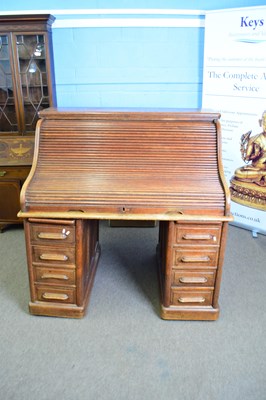 Lot 319 - Late 19th/early 20th century oak roll front...