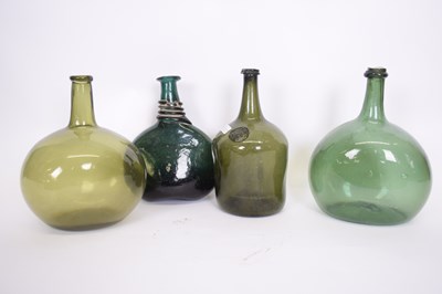 Lot 49 - Group of four 18th century green glass bottles...