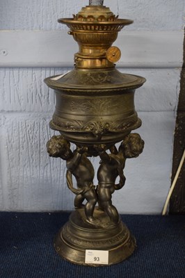 Lot 93 - Oil lamp, the lamp decorated with cherubs in...