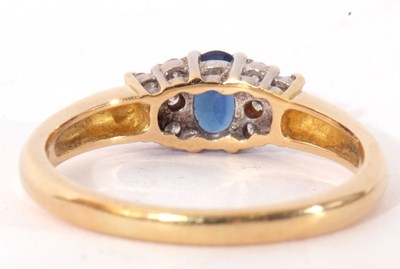 Lot 44 - Sapphire and diamond ring centring an oval...