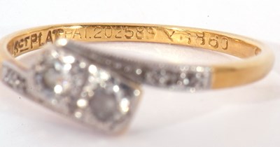 Lot 57 - Antique diamond cross-over ring centring two...