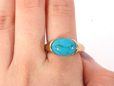 Lot 65 - Modern 9ct gold turquoise set dress ring, the...
