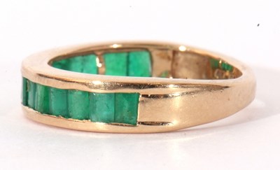 Lot 112 - Modern 9ct gold and emerald half hoop ring...