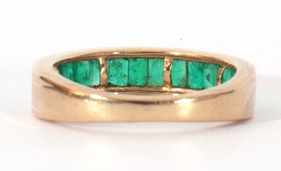 Lot 112 - Modern 9ct gold and emerald half hoop ring...