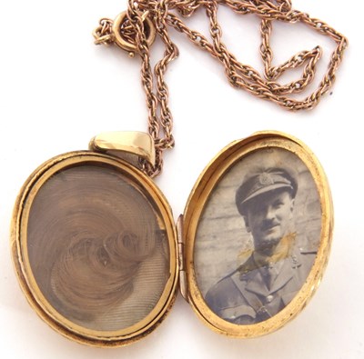 Lot 222 - Gold back and fornt oval hinged locket...