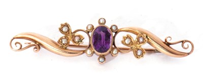 Lot 253 - Amethyst and seed pearl scroll brooch centring...