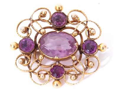 Lot 254 - Yellow metal and amethyst brooch, the ornate...