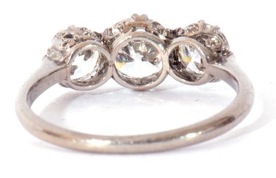 Lot 12 - Three-stone diamond ring featuring three round...