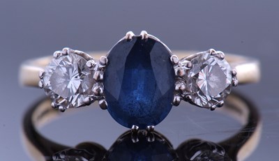 Lot 164 - Sapphire and diamond three stone ring, the...