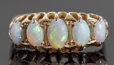 Lot 166 - 18ct gold five stone opal ring featuring five...