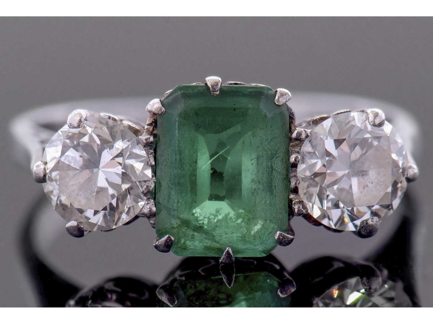 Lot 186 - Emerald and diamond three stone ring, the...