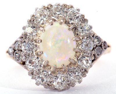 Lot 187 - Opal and diamond cluster ring centring an oval...
