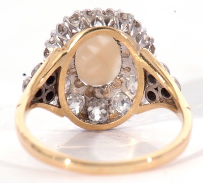Lot 187 - Opal and diamond cluster ring centring an oval...